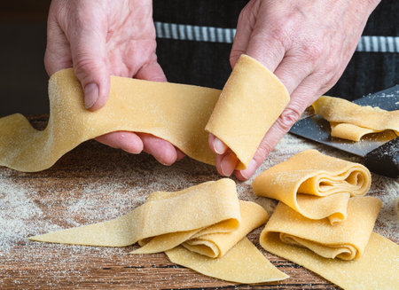 Hands with fresh pappardelle pasta.の写真素材