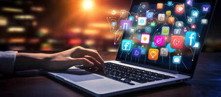 Hands typing on laptop with network social media icons fire ware technologyの素材