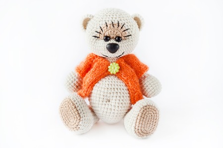 knitted toy bear in the orange sweaterの写真素材