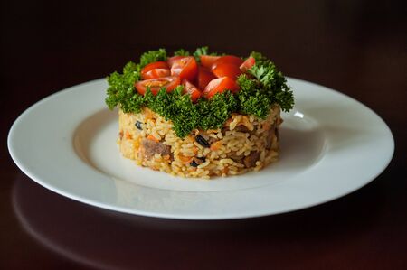 uzbek plov on plate - dish with meat, rice and vegetablesの写真素材