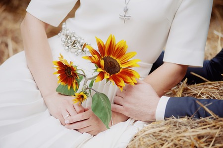 beautiful wedding bouquet of flowers in the hands of the brideの写真素材