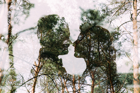 Double exposure lovers in the forestの写真素材