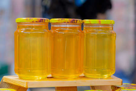 Fresh fragrant honey in jars for your health, front viewの写真素材