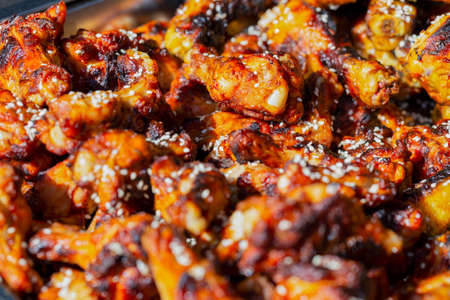 Fresh appetizing grilled chicken legs, background, top view