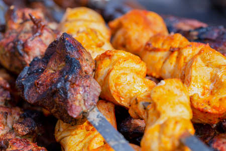 Juicy fresh appetizing meat and chicken skewers on skewers, background, top view, close-upの写真素材
