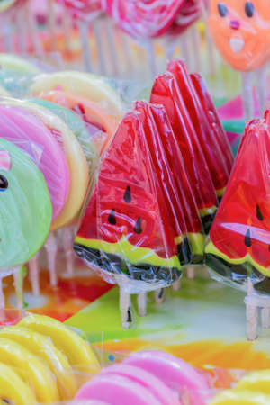 Lots of delicious multi-colored candies on a stick, front view, close-upの写真素材