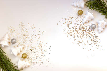 Christmas attributes on a light background, pine branches, balls, Christmas trees, stars, flat lay, copy spaceの写真素材