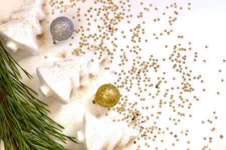Christmas attributes close-up on a light background, pine branches, balls, Christmas trees, stars, flat lay, copy spaceの写真素材