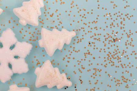 New year poster with snowflake and Christmas trees on sides close-up on blue background with stars, flat lay, copy spaceの写真素材