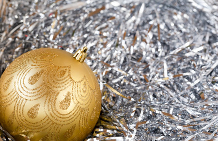 Golden christmas ball on christmas decorations, front view, copy space, close-up, backgroundの写真素材
