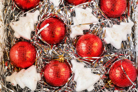 Red Christmas balls and white artificial Christmas trees on decorations in a box, top view, backgroundの写真素材
