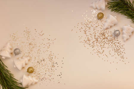 Christmas attributes on a milky background, pine branches, balls, Christmas trees, stars, flat lay, copy spaceの写真素材