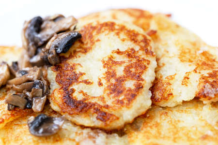 Fresh appetizing potato fritters with fried mushrooms. Top viewの写真素材