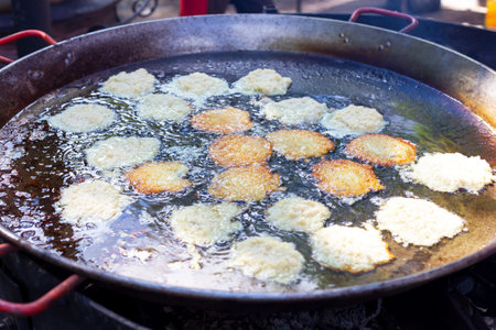 The potato fritters are fried in a large frying pan. Very tasty and appetizing. Top viewの写真素材