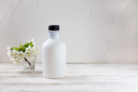 White bottle on a light background. Aroma diffuser, cosmetics, perfumes. Selective focusの写真素材