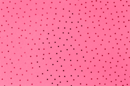 Pattern of small stars on a magenta background. Selective focus. Color of the year 2023