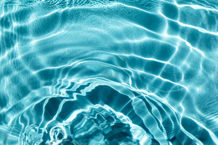 Waves on the water in the pool. Basin, river, ocean. Blue textured background for your design....
