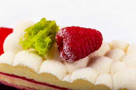 Close-up of red raspberry berry on fluffy buttercream on cakeの写真素材