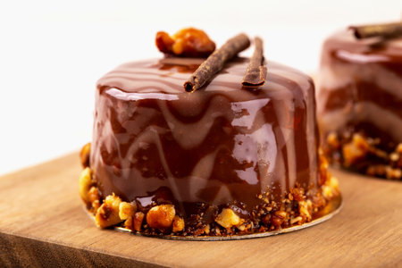 Fresh delicious chocolate souffle cake on wooden board close-up. Caramel glaze and decoration add...