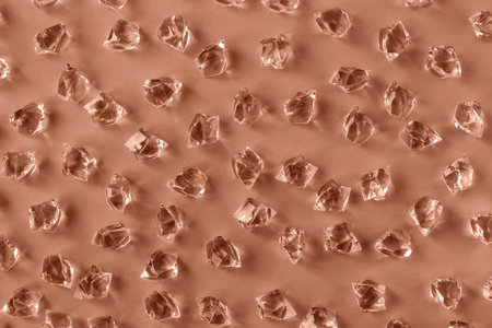 Pattern of ice pieces on Mocha brown background. Selective focus.