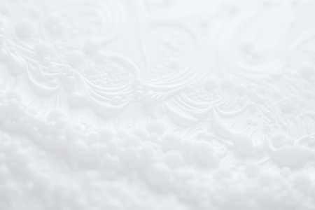 White blurred background. Ethereal white surface featuring intricate swirling patterns and raised dots, offering an elegant and modern abstract background. Selective focus, defocusの素材