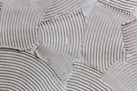 Abstract plaster texture closeup with decorative lines. Plaster curved lines create artistic...