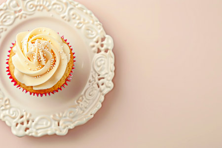 Cupcake with copy space. Delicious cupcake with swirl of creamy frosting and decorative sprinkles sits on plate, showcasing its delightful design and inviting appearance, perfect for dessert loversの素材
