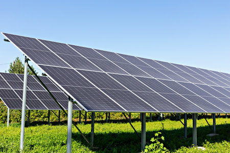 Solar energy. Solar panels are arranged in rows on lush green field, capturing sunlight efficiently...