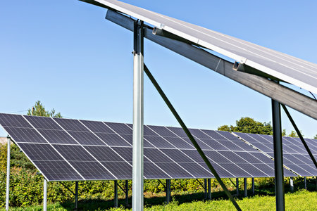 Solar energy. Solar panels arranged in rows capturing sunlight in green field highlighting importance of renewable energy sources and sustainable practices in technology and environmental conservationの写真素材