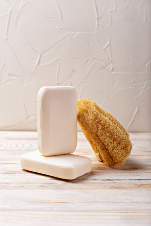 Health and hygiene. Natural soap bars in minimalist arrangement with loofah, showcasing organic textures and serene ambiance, perfect for wellness and beauty themesの写真素材
