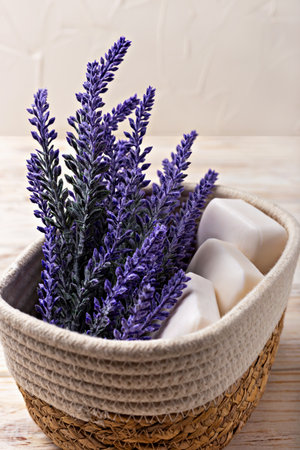 Lavender soap. Beauty and health. Lavender flowers in woven basket alongside natural soaps create serene spa atmosphere, enhancing relaxation and tranquility with soft textures and soothing colorsの写真素材