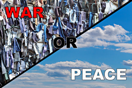 War or peace. Textured pieces of fabric tied into camouflage netting on one side and calm blue sky on other, concept of war and peace, death and lifeの写真素材