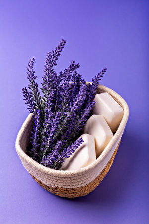 Lavender soap. Beauty and health. Lavender flowers in woven basket complement natural soap bars, creating serene and calming atmosphere, perfect for wellness and relaxation themesの写真素材