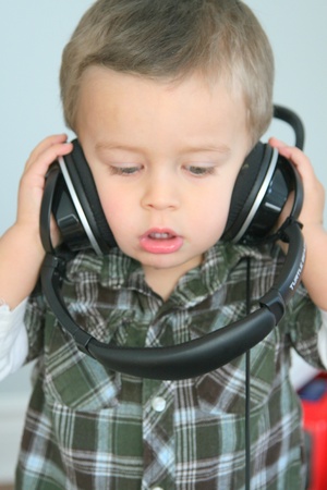 Baby with headphones listening to musicの写真素材