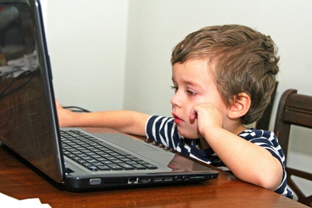 Toddler looking at computerの写真素材