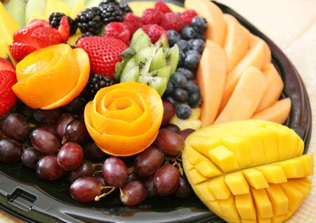 Variety of fresh healthy fruit on a plateの写真素材