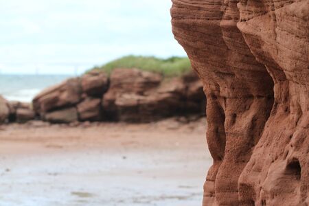 Wind erosion of ruby-red sandstone cliffs and coveted sandyの写真素材