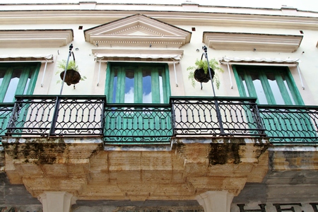 Old architectural building with wrought iron railing in Havana, Cubaのeditorial素材