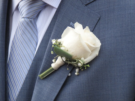 Closeup of  white rose on the lapel of a bridegroom
