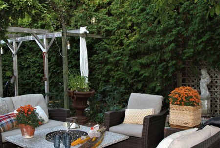 Outdoor Seating Arrangement Around A Gas Fire Pit Table In The