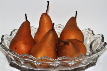 pears in a glass plate on a white background. close-up