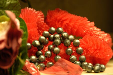 close up of a silver pearl necklace on peach colorの写真素材