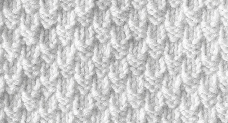 The background is white. The texture of the knitted fabric is made of woolen threads handmade.の写真素材