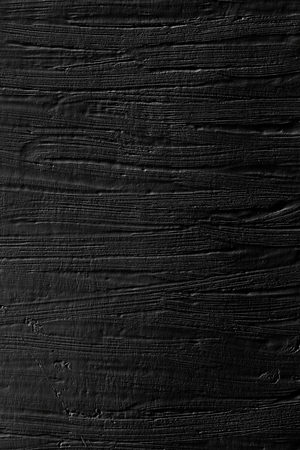 The background is black. Texture of paint and plaster on the wall with a pattern of strips.の写真素材
