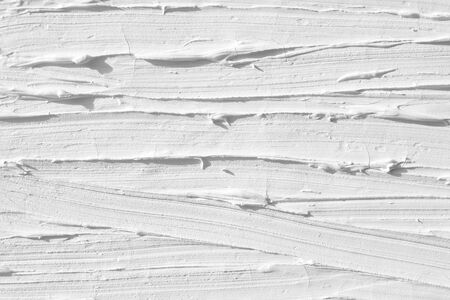 The background of the white color is painted by paints with the help of a brush, handmade by an artist. Texture paint with pattern strips, continuous lines.の写真素材