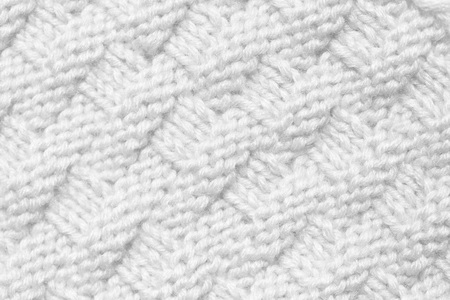 The background is white. The texture of the knitted fabric is made of woolen threads handmade.