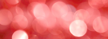 Shiny red New Year background for holiday card. A wallpaper with a blurry pattern.