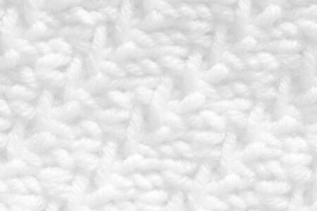 Texture pattern knitting with acrylic thread. Manual work with knitting needles, white background of...