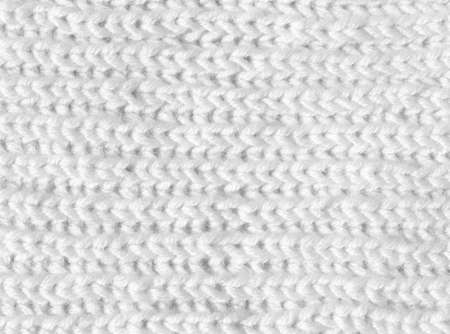 Knitting from woolen threads. Texture for the New Year's postcard. White background for various purposes.の写真素材