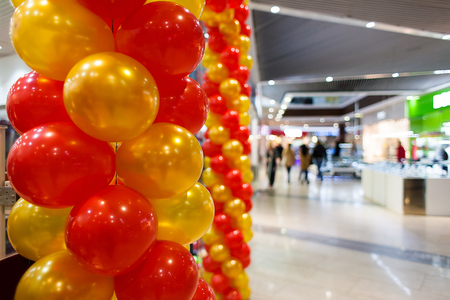 Red and orange balloons in mall.の写真素材